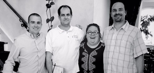 Triangle Green Cleaning leadership team poses together at 518 West Italian Café during their farewell lunch, honoring their roots and shared beginnings.