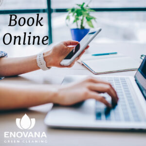 Person using phone and laptop to book house cleaning online with Enovana Green Cleaning